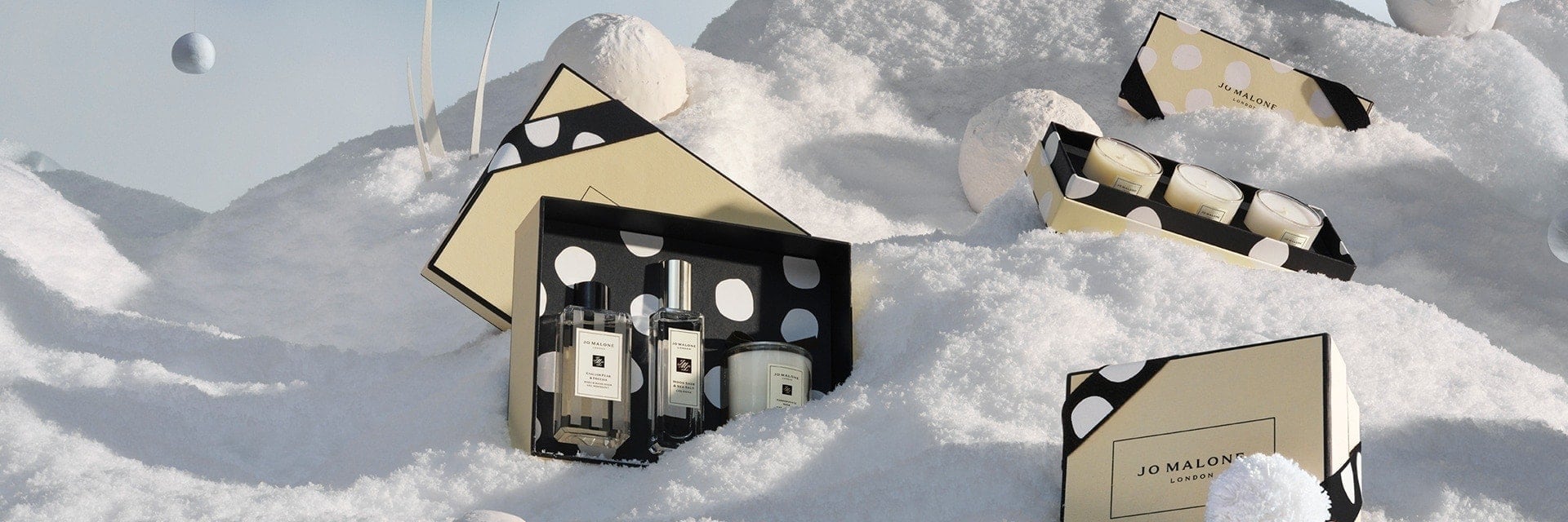 christmas limited edition products surrounded by snow and snowballs. 